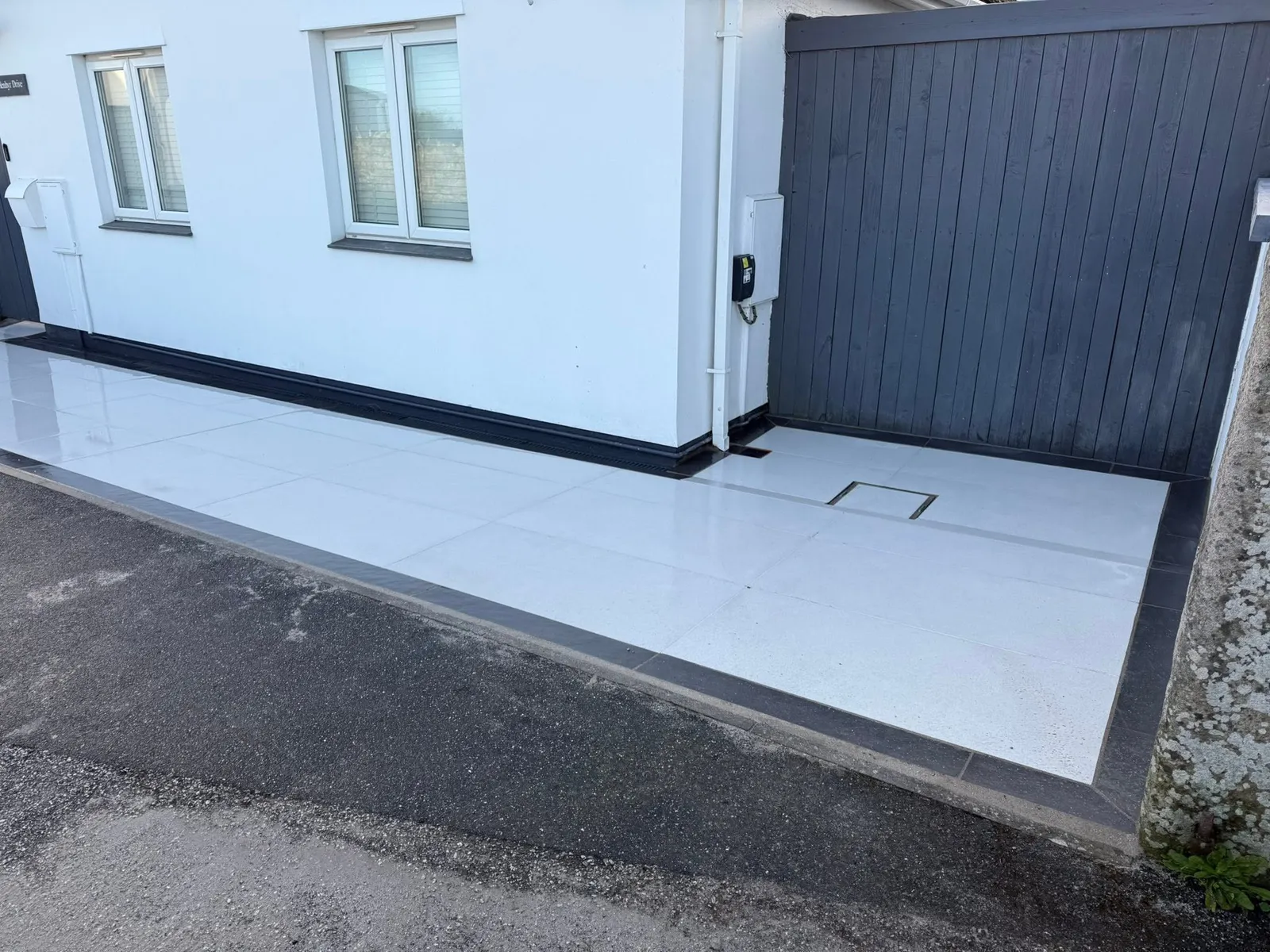 Tiled paving beside a driveway