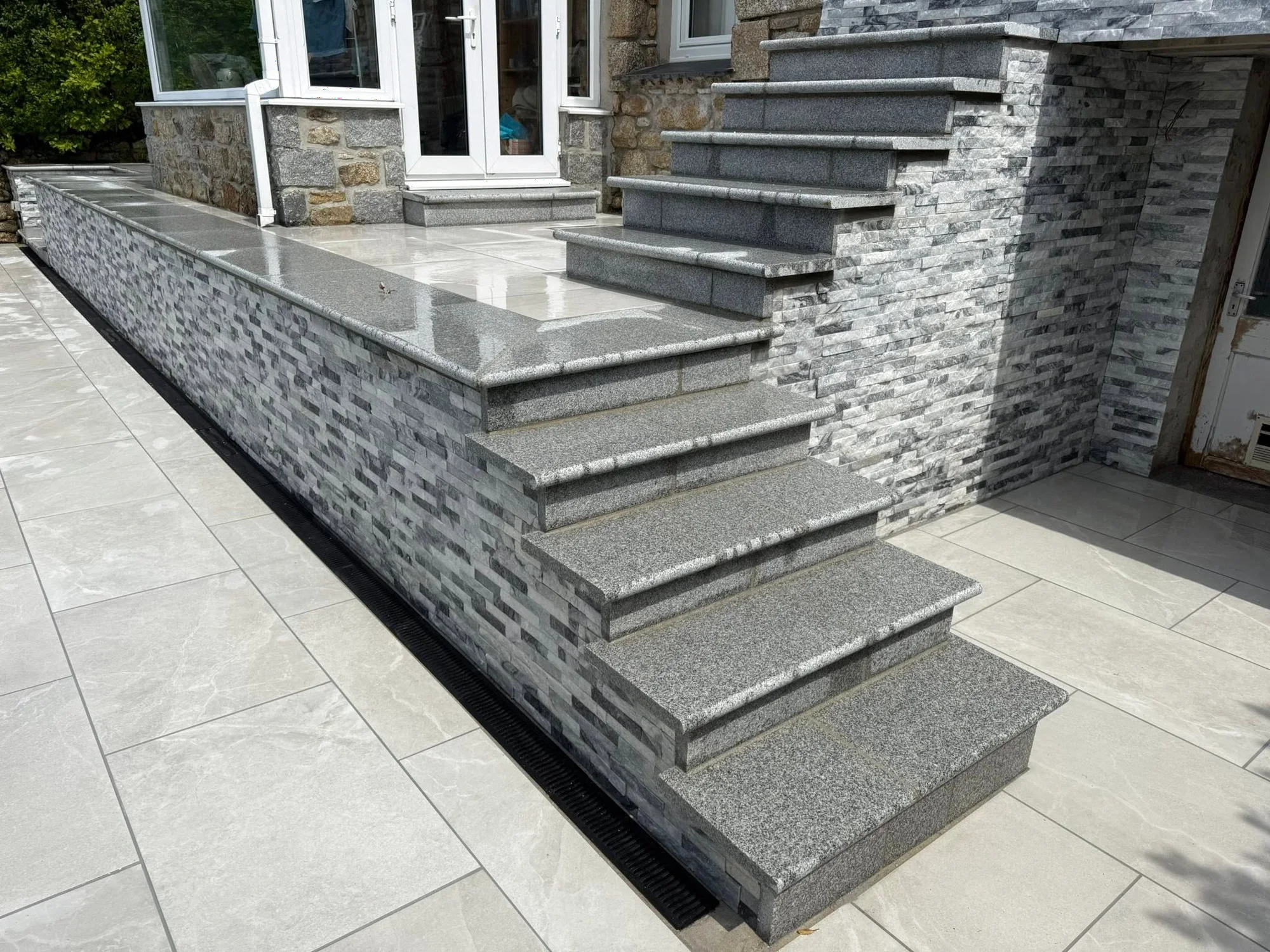 Stone steps and paved terrace built by Lee Hunter Stone Mason
