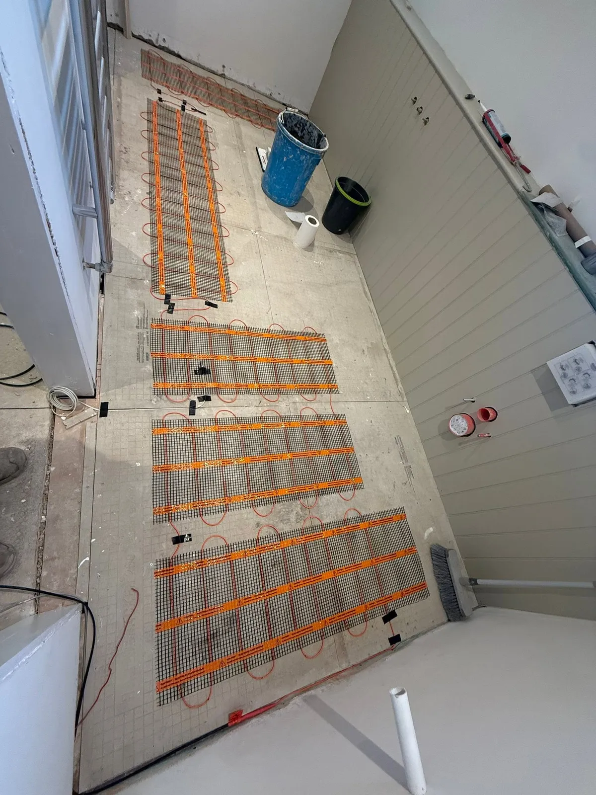 Electric underfloor heating mats, ready for the electrician
