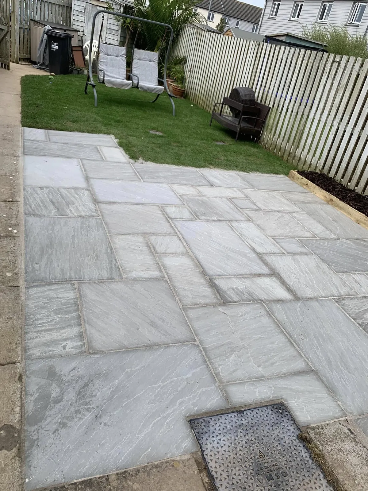 Grey paved patio and lawn